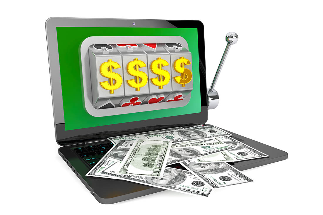 Online casino concept. Slot machine inside laptop with dollars on a white background